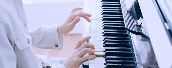 Boy playing piano on Forte lessons